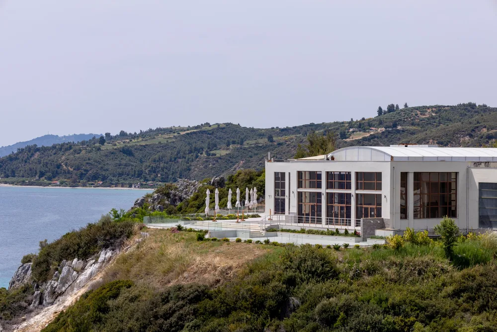 The thermal spa at Loutra Agia Paraskevi standing above the rocky coast and blue sea.